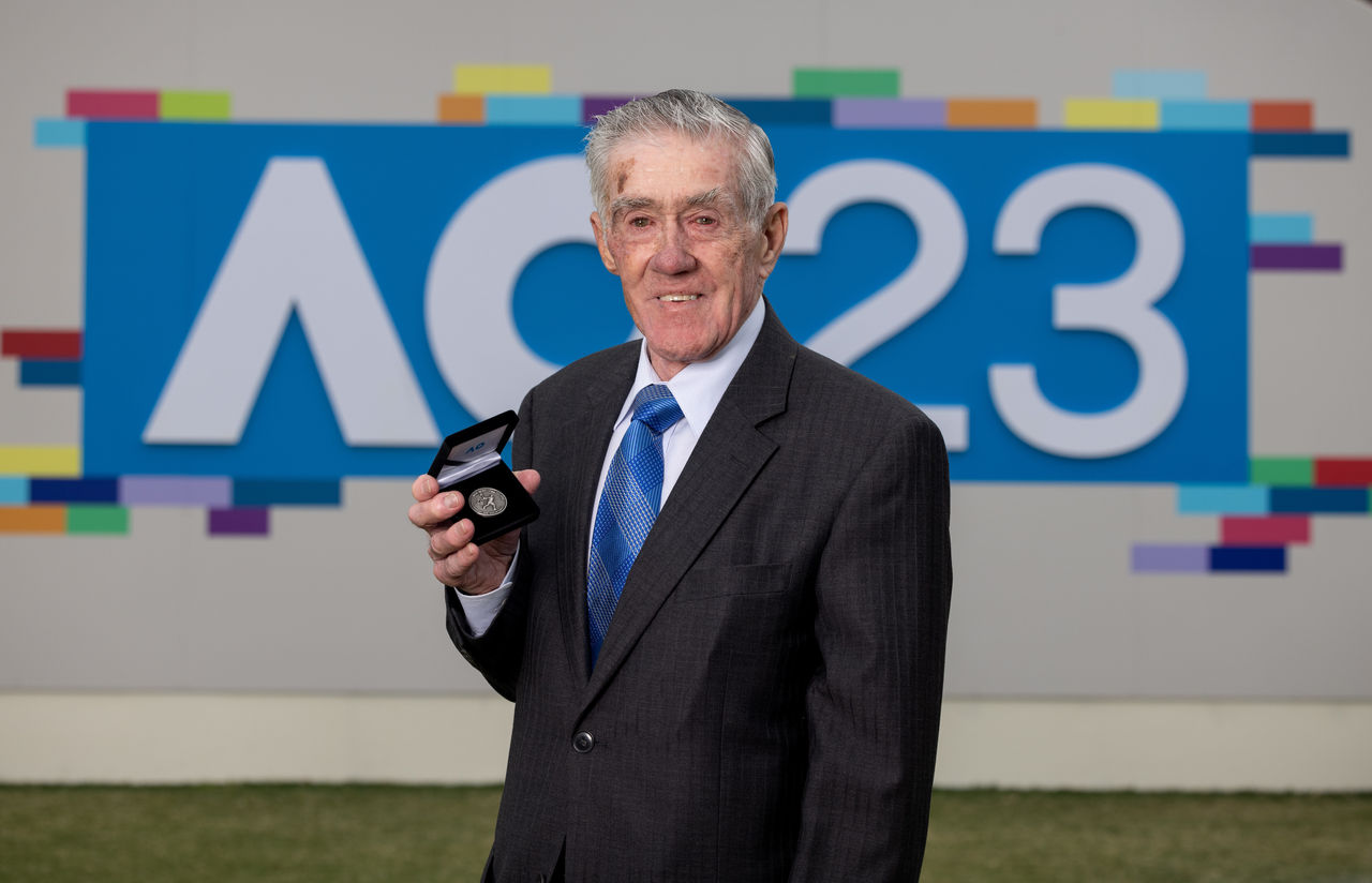 Ken Rosewall AM MBE, Brenda Fruhvirtova, youngest player in the women's draw, Luca Van Assche, second youngest player in the men's draw and Tennis Hot Shots players from Ascot Vale Tennis Club launched The Australian Open 2023 coin featuring Ken Rosewall ahead of the 2023 Australian Open at Melbourne Park Sunday, January 15, 2023. MANDATORY PHOTO CREDIT Tennis Australia/ FIONA HAMILTON