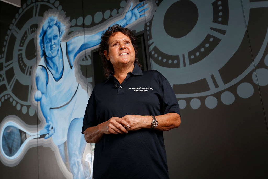 DARWIN, AUSTRALIA - AUGUST 29: Evonne Goolagong Cawley stands in front of a mural of her painted by a group of local artists, including David Collins and Indigenous artists Shaun Lee ‘Hafleg’ and Jesse Bell to celebrate and recognise her incredible achievements during the National Indigenous Tennis Carnival at the Darwin International Tennis Centre on August 29, 2019 in Darwin, Australia. (Photo by Darrian Traynor/Getty Images)