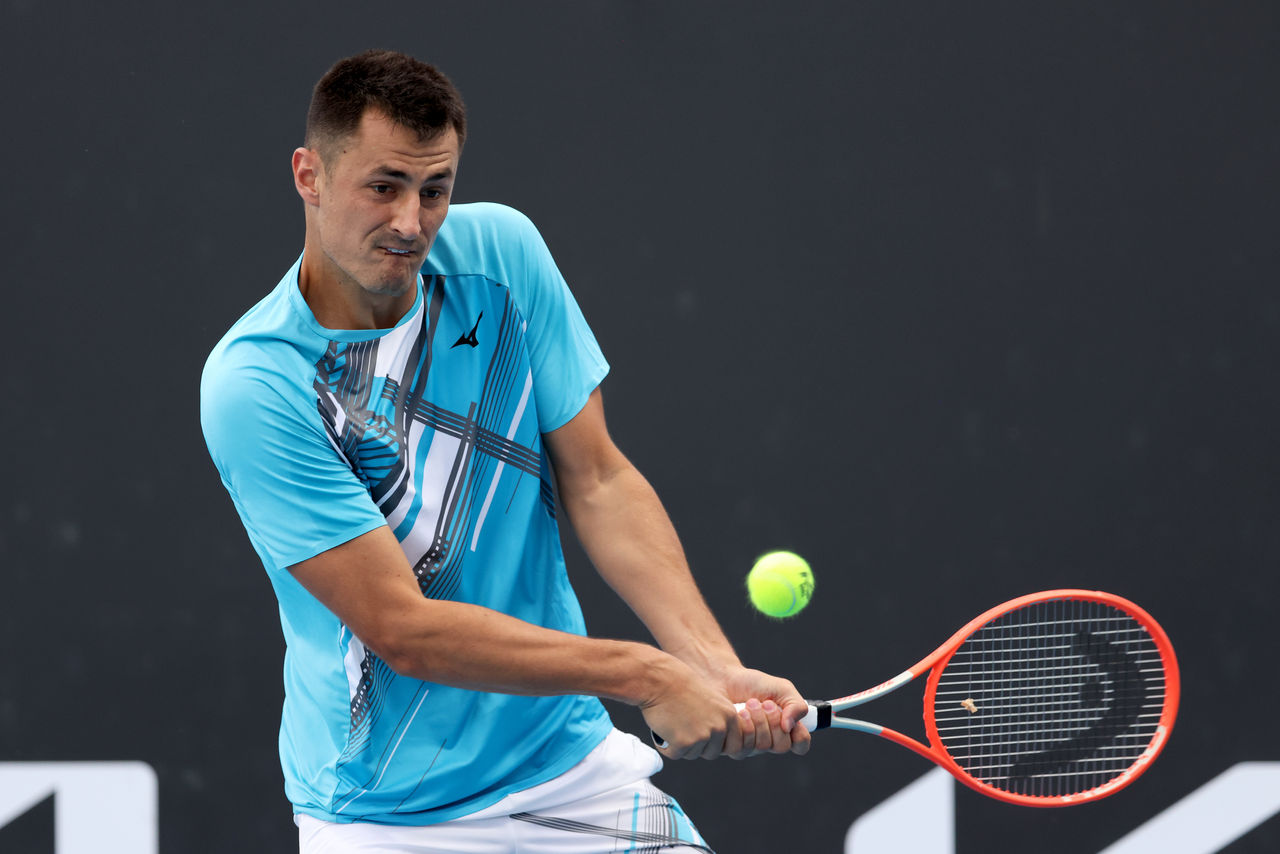 Bernard TOMIC of Australia plays a backhand in his singles match against Yuichi SUGITA of Japan on court 8 during Day 1 of the Australian Open at Melbourne Park on Monday, February 8, 2021. MANDATORY PHOTO CREDIT Tennis Australia/ JONATHAN DI MAGGIO